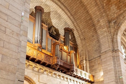 Large wooden church organ in an architecturally impressive interior, Paris