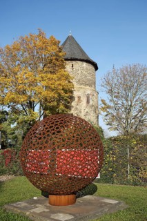 Historic Alexander Tower built in the 15th century and sculpture with ball, lattice, autumn