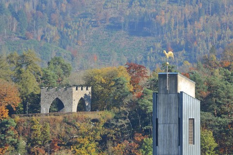View of memorial in the spa gardens and church tower of St. Peter and Anna with autumn atmosphere,