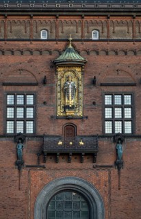 Brick façade with gilded sculpture of Bishop Absalon, St City Hall in the National Romantic style