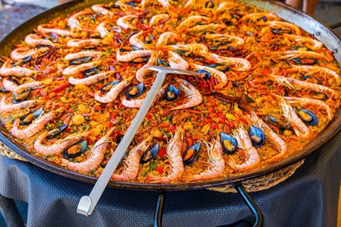 Giant pan and ladle with the Spanish national dish paella, hippie market Es Canar, Ibiza, Balearic