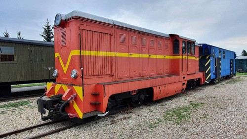 Red and yellow diesel locomotive on narrow-gauge tracks in the open air, Railway Museum, Elk, Elk,