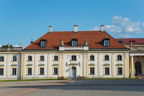 Baroque building with red tiled roof and classicist windows under a blue sky, Branicki Palace,
