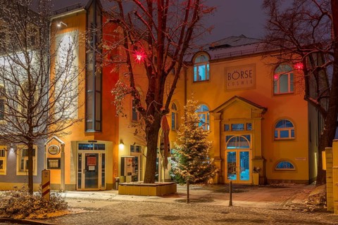 Star trees in front of the stock exchange at dusk, slightly snow-covered, Coswig, Saxony, Germany,