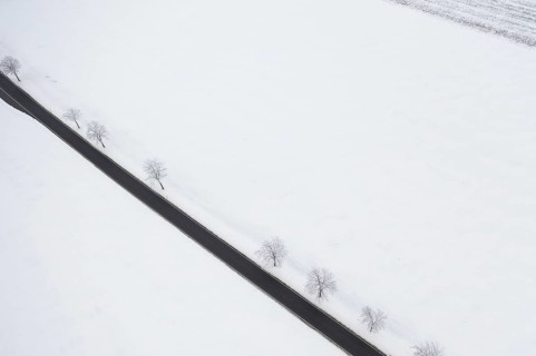 Aerial view of a straight country road in the snow, near Oederan, Saxony, Germany, Europe
