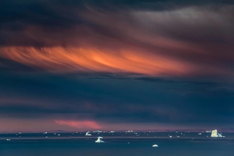 Evening light and atmosphere in fjord with icebergs, cloudy, autumn, Scoresby Sund, East Greenland,
