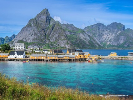 Sakrisøy fishing village, yellow fishermans cabins at the sea on small island Sakrisøy, near