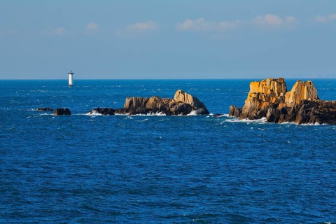 Evening view from the Pointe du Grouin with a view of the Phare de la Pierre-de-Herpin and striking