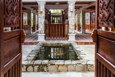 Interior of tropical hotel with a small pond