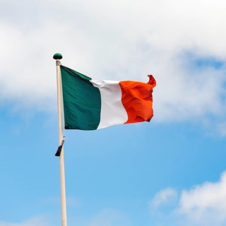 Irish national flag, tricolour waving against a slightly cloudy sky, Dublin, Ireland, Europe