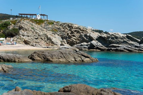Rocky coastal landscape with crystal clear water and cliffs, peaceful natural scenery, Sarti,