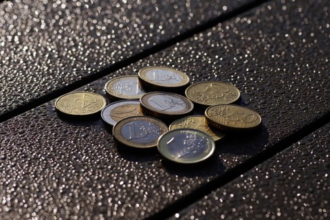 Euro, coins, small change, glow, Various cent and euro coins lie on a table in front of a blurred,