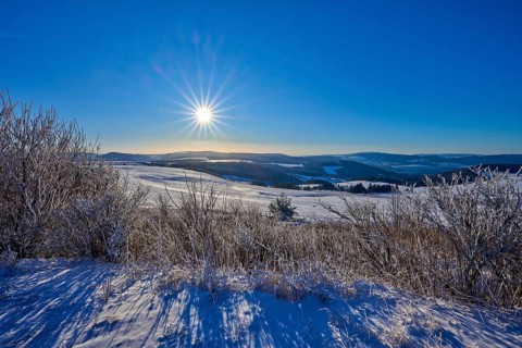 Bright sun over white hills with clear sky, winter, Wasserkuppe, Gersfeld, Rhön, Hesse, Germany,