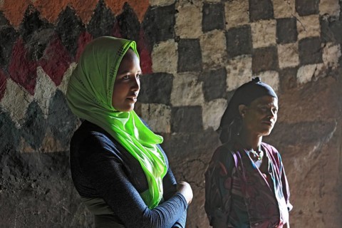 Mother and daughter with headscarf in their round hut in the south of the country, Ethiopia, Africa
