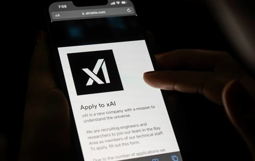 In this photo illustration, A person browses website of xAI, displayed on a mobile phone, Elon Musk