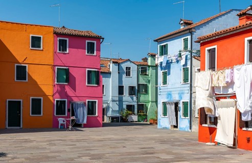 Colourful houses with washing lines, colourful house facades, alleyways on the island of Burano,