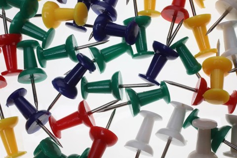 Lots of colourful pins, pushpins, drawing pins