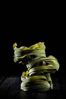 Low key photo of italian tagliatelle with spinach