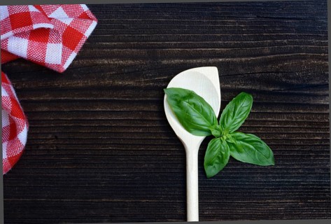 Cooking spoon and basil (Ocimum basilicum)