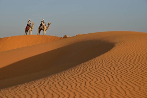 Men on camels in the dunes of Meroe, Black Pharaohs, Nubia, River Nile, Sudan, Africa
