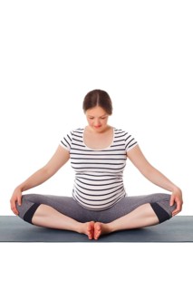 Pregnancy yoga exercise, pregnant woman doing asana Baddha Konasana Bound Angle Pose isolated on