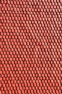Façade cladding made of red textured panel