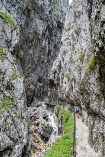 Hiker in a gorge, Hammersbach flows through Höllentalklamm, near Garmisch-Partenkirchen,