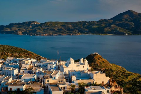 View of Plaka village on Milos island with traditional greek white houses with Greek Orthodox