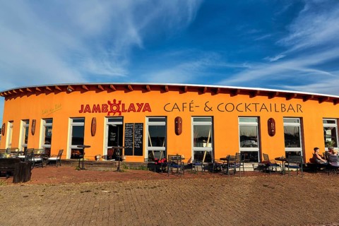 Colourful cafe, cocktail bar Jambolaya, gallery, decoration with West African handicrafts in the