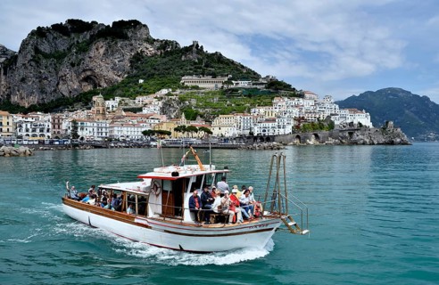 Tour boat in front of town Amalfi, Amalfi Coast, Costiera Amalfitana, Province of Salerno,