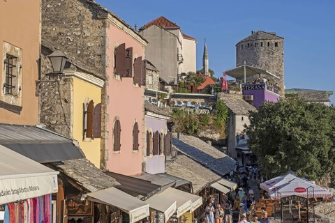 Tourists and souvenir shops in the 16th century Old Town of Mostar, built by the Ottomans,