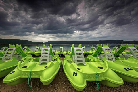 Pedal boats on the beach in Sainte Croix du Verdon, Lac de Sainte-Croix, thunderstorm atmosphere,