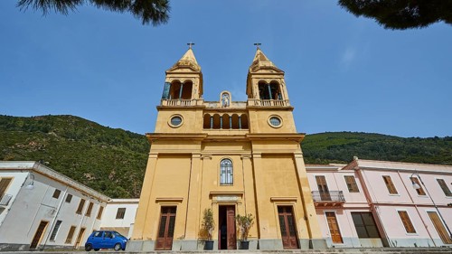 Super wide angle, oblique from below, ochre-coloured facade, two church towers, Santuario della