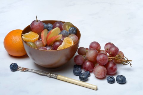 Various pieces of fruit in bowl, fruit salad