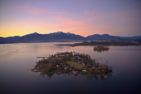 View from above over the Chiemsee at sunrise, Fraueninsel in the foreground, behind it Herreninsel