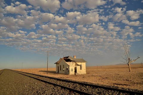 Derelict house by railroad tracks, former German railway station of Garub, Aus, Karas Region,