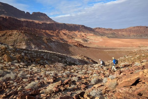 Hikers in the amphitheatre near De Riet, Huab Dry River, Kunene region, Namibia, Africa
