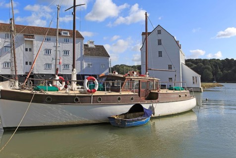 Historic boat and Tide Mill on the waterfront, River Deben, Woodbridge, Suffolk, England, UK