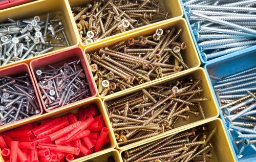 Colourful carpentry box of metal screws viewed from above