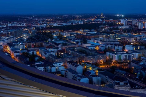 View of the city from the City Tower at blue hour towards the Monument to the Battle of the