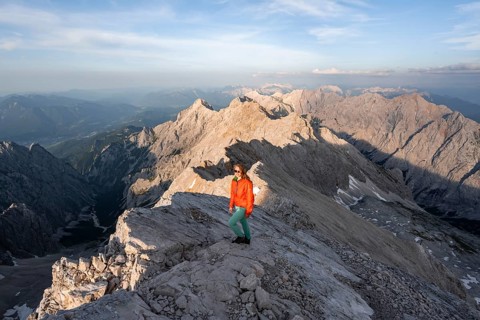 Mountaineer on a steep rocky ridge, impressive mountain landscape, view of the Höllental and the