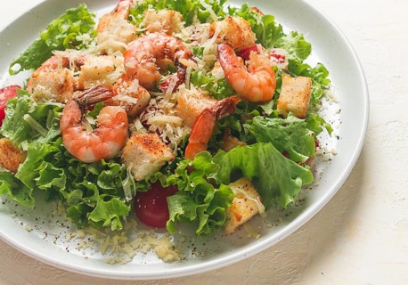 Caesar salad, with shrimp, on a white background, homemade, no people