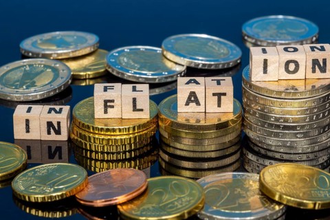 Symbolic image of inflation: euro coins and letters displaying the word INFLATION