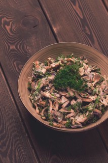 Chicken and mushroom salad, with herbs, seasoned with white sauce, close-up, rustic style, on a