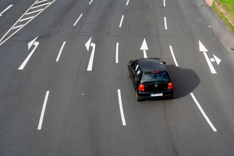 Road markings, turning lanes, directional signage at an intersection, turning, straight ahead,