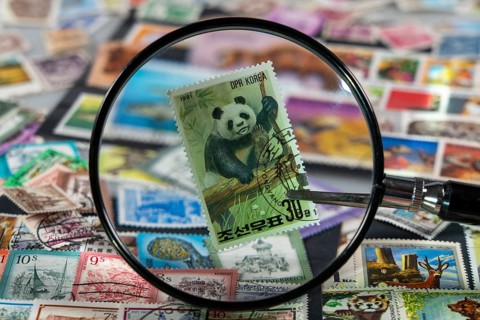 Stamp collection, collecting, postage stamps, postage stamps from different countries, magnifying