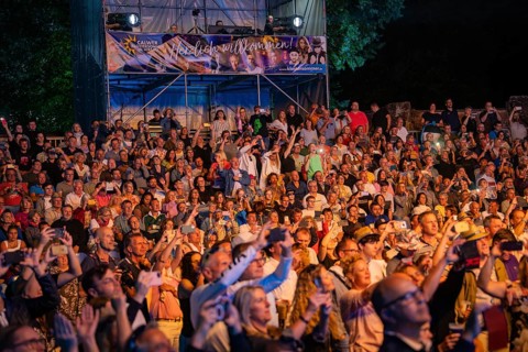 Large crowd at night concert with stage and welcome banner in the background, Klostersommer, Calw