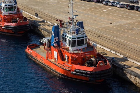 High angle view of docked orange, white and blue Capo D'Orlando and Megrez tugboats, Port of