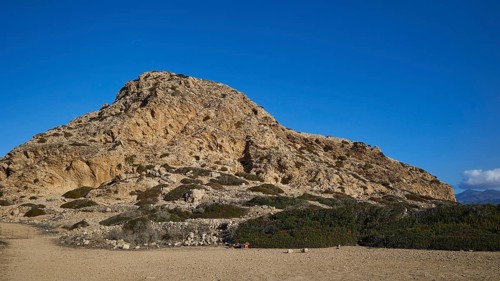 Rocky hill with sparse vegetation under a clear blue sky, Acropolis Hill, Arkasa, west coast,