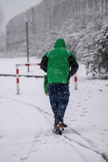 Winter weather, heavy snowfall, city centre traffic, man on e-scooter in driving snow, Essen, North